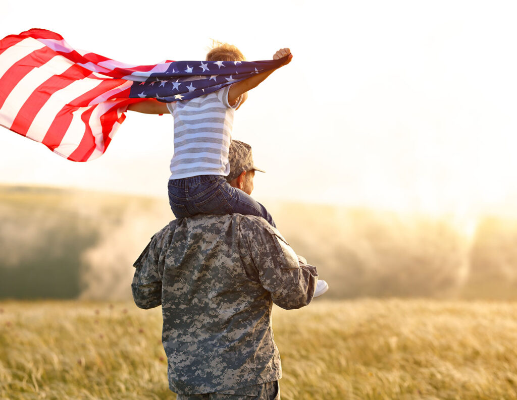 Veteran Holding Child